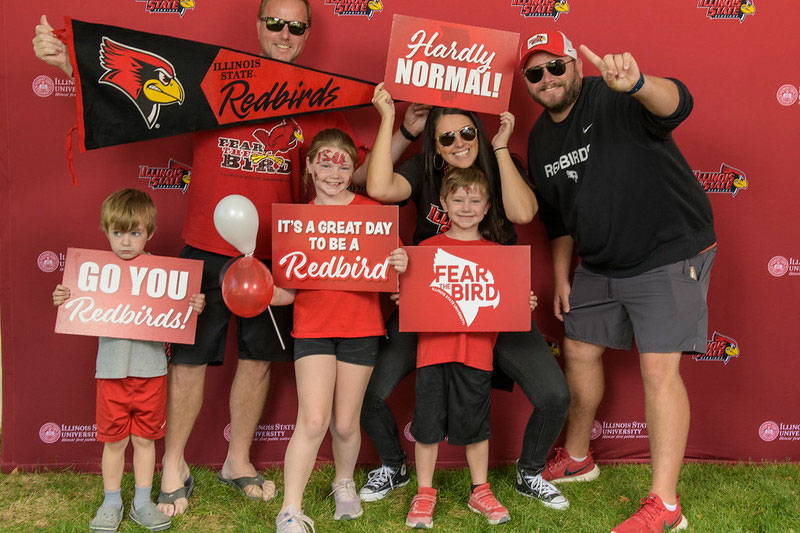 Family posing with ISU Family Weekend printables.