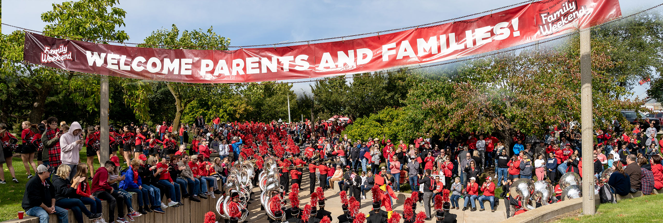 Students and family under the Family Weekend event banner .